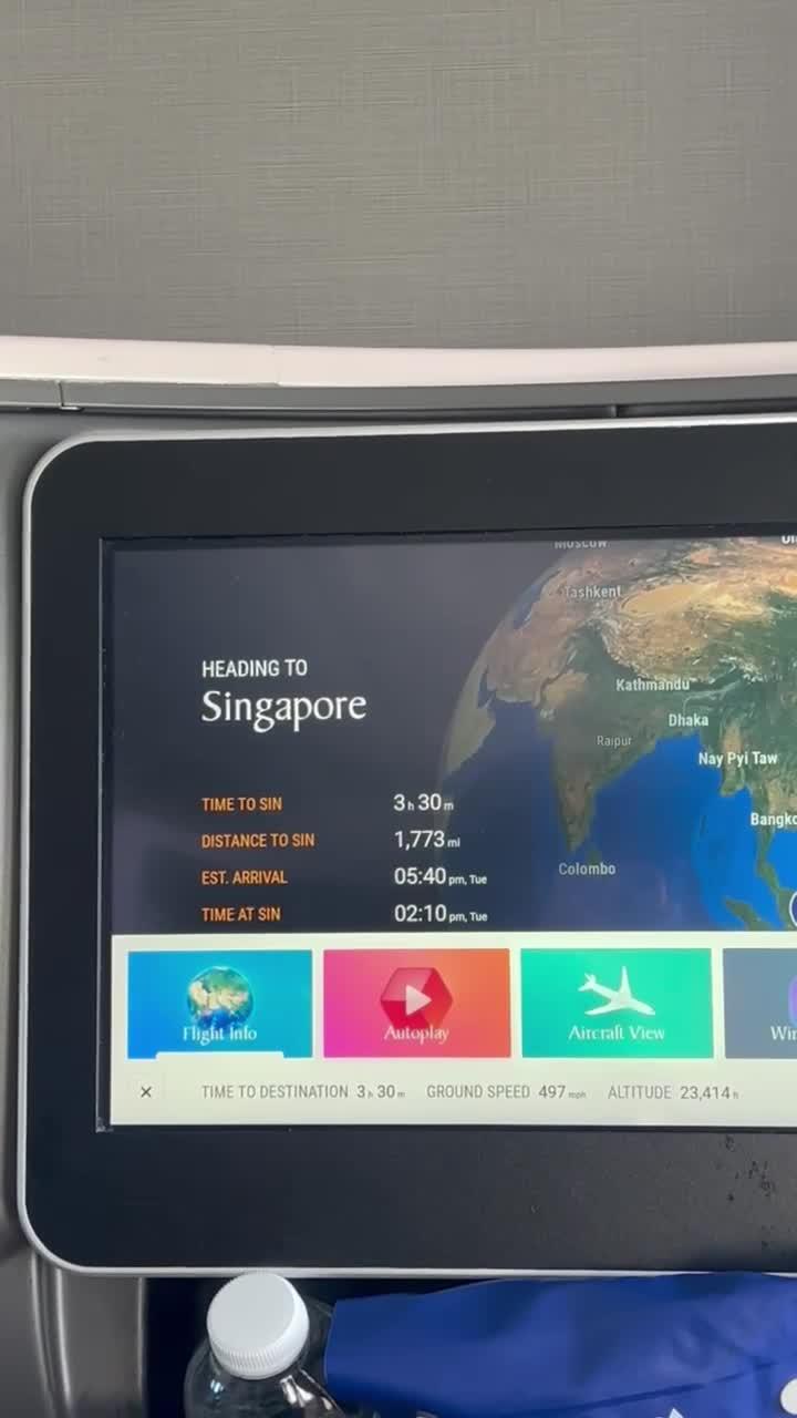 In-flight entertainment screen showing flight heading to Singapore
